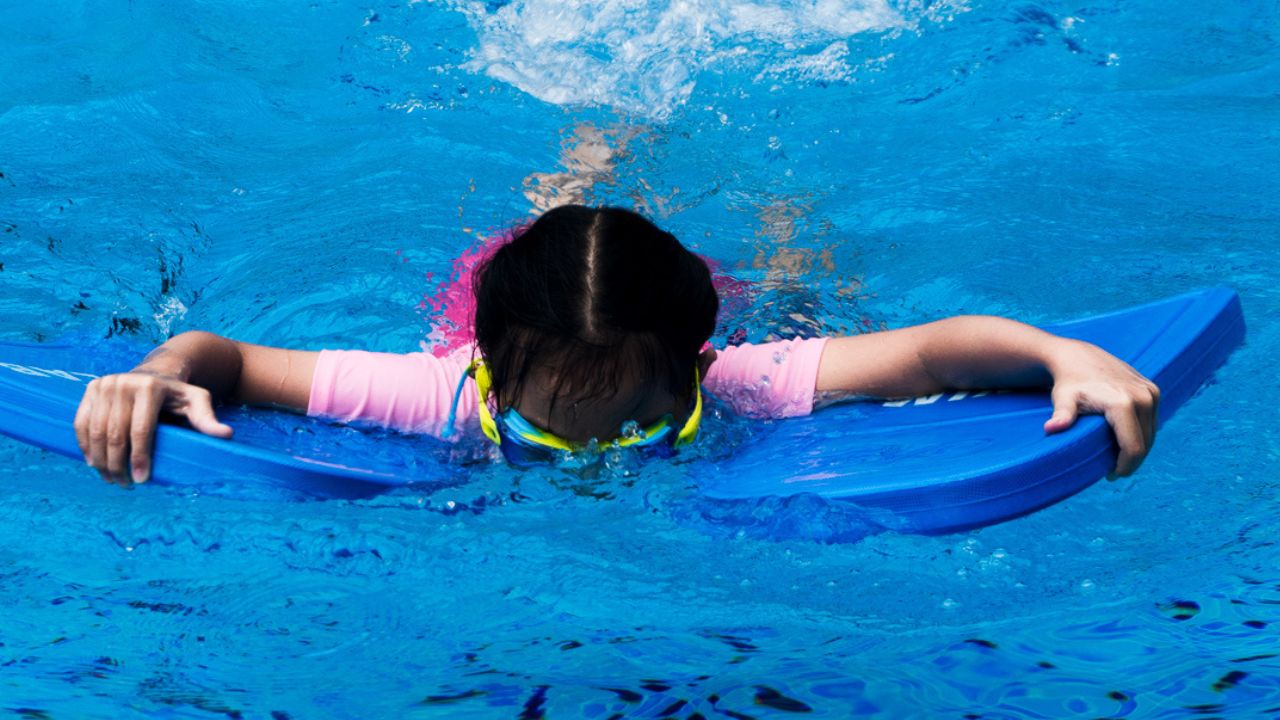 Child using Kickboards to Learn to Swim at The Swim Lab