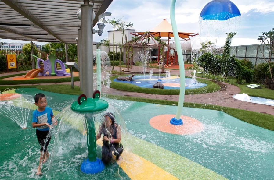 Children enjoying water activities at Tampines1 Water Playground in Tampines.