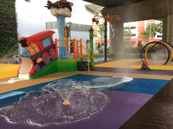 Kids splashing around a unique water playground featuring vehicular slides and an airplane-themed waterspout.