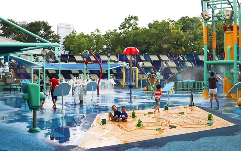 Kids laughing and splashing in the water park facilities at Waterworks, Science Centre SG.